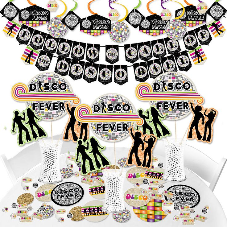 disco party decorations and tableware on a white table