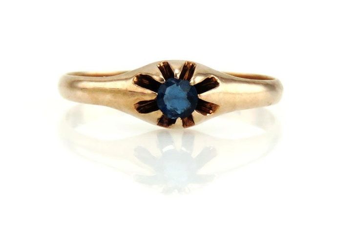 "Presented is a very pretty gold ring with a midnight blue stone. The blue, sapphire or sapphire-like stone is approximately 12 points in weight and a lovely deep blue color, set on upward reaching prongs that form an eight-petaled flower rising up out of the lovely polished gold band. The ring has a continuous graduated band of about 3 mm to 1.5 mm in width. The inside of the ring is stamped \"14\" indicating its gold purity, and we guarantee this for you. The condition of the ring is good. The Vintage Blue Sapphire Ring With Bezel Setting, 14k Gold Blue Sapphire Ring With 17 Jewels, Formal Blue Birthstone Ring In 14k Gold, Antique Sapphire Birthstone Ring For Formal Occasions, Antique Blue Round Cut Sapphire Ring, Antique Blue Sapphire Ring With Round Cut, Sapphire Solitaire Engagement Ring, Art Deco Sapphire Ring, Vintage Sapphire Ring