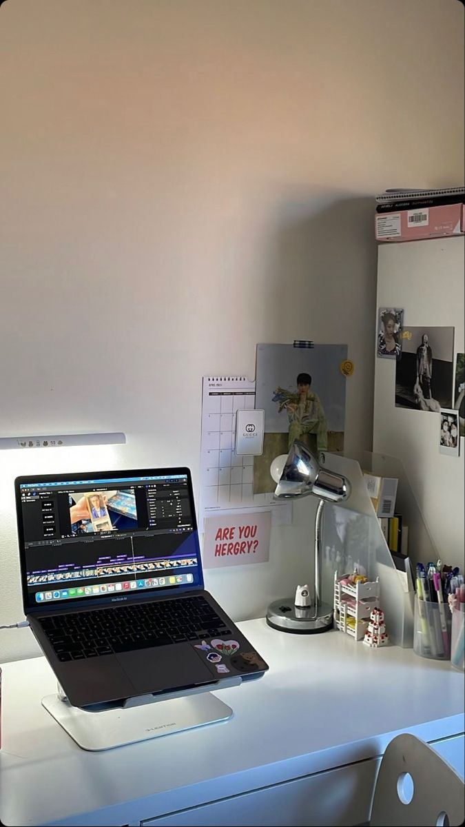 a laptop computer sitting on top of a white desk