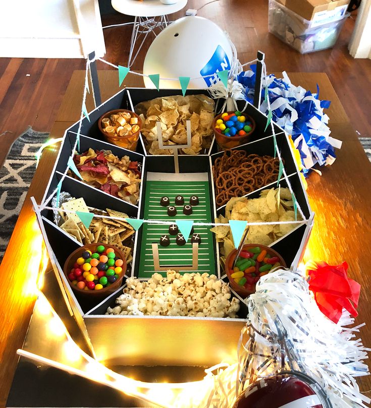 a football party tray with snacks and candy