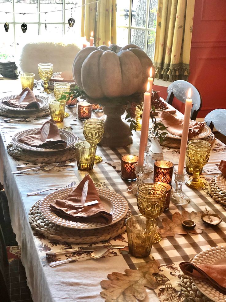 a dining room table set for thanksgiving dinner