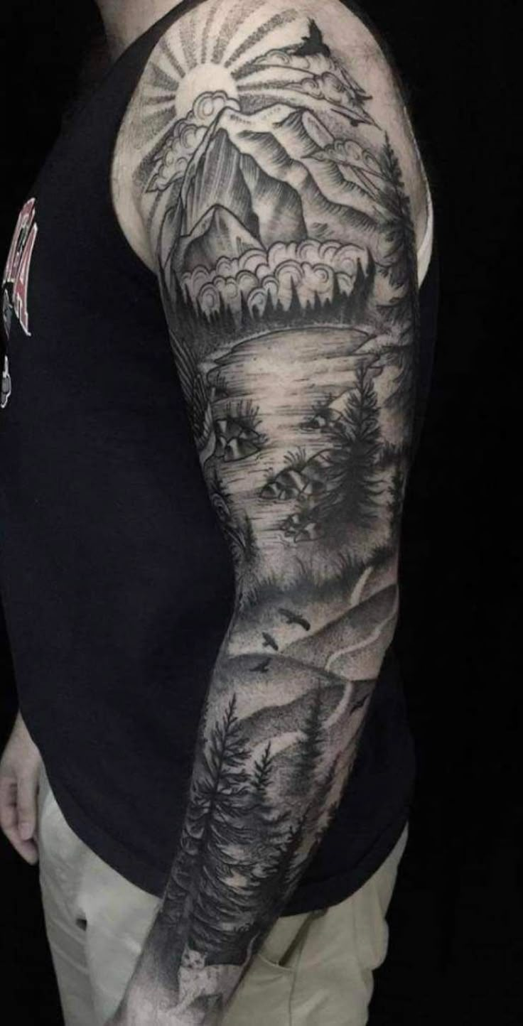 a man with a full sleeve tattoo on his arm