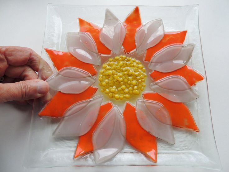 a person is making a flower out of plastic