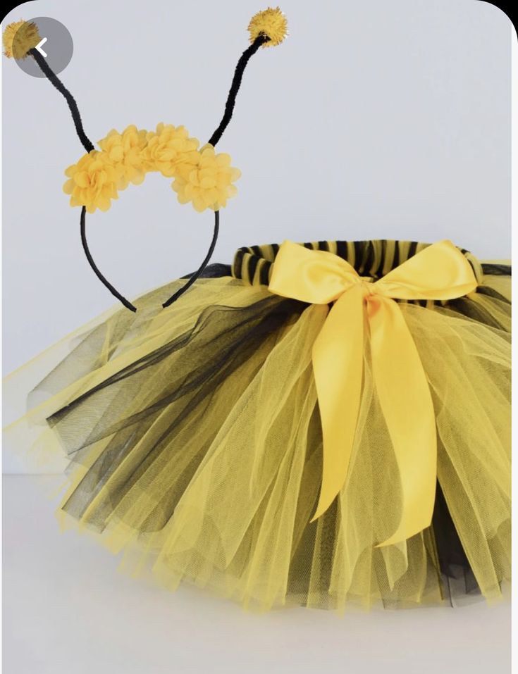 a yellow and black tutule with flowers on it's headbands