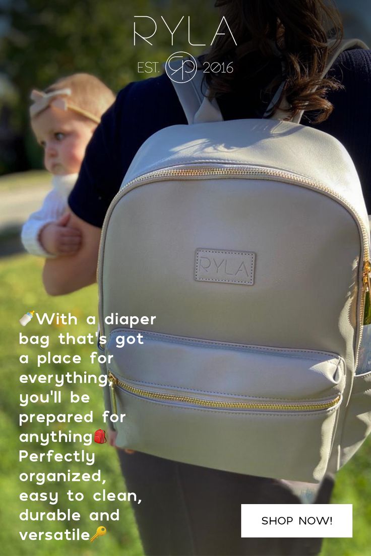 a woman carrying a baby in a white backpack with the words, ryla est diaper bag that's got everything you need