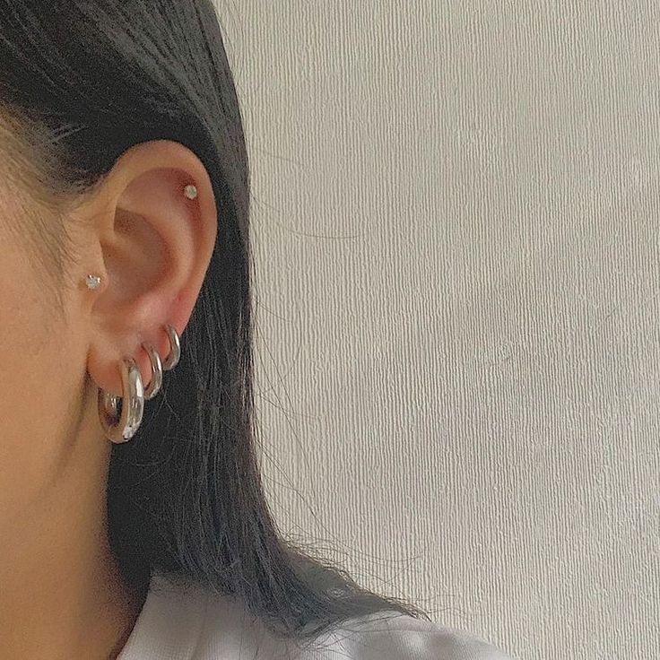 a close up of a person wearing some kind of earring on their left side