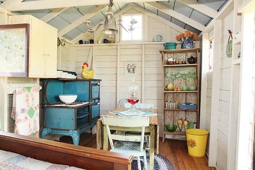 an old fashioned kitchen and dining area in a small cabin style home with wood floors