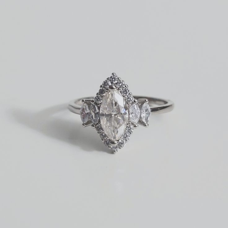 an engagement ring with three pear shaped diamonds