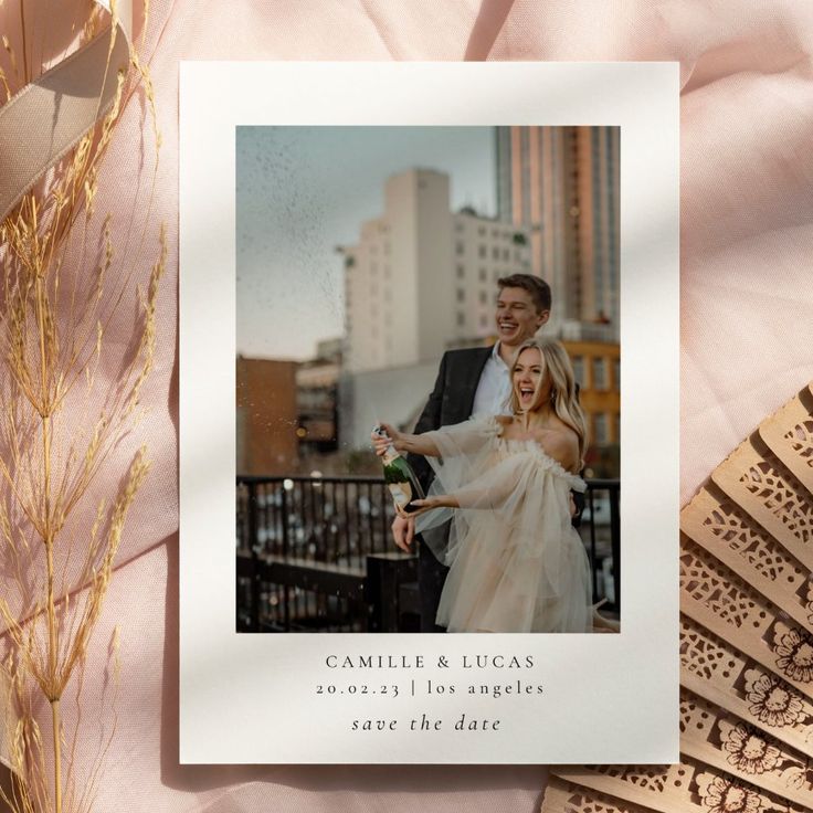 a wedding photo with the bride and groom on it next to some fanned fans