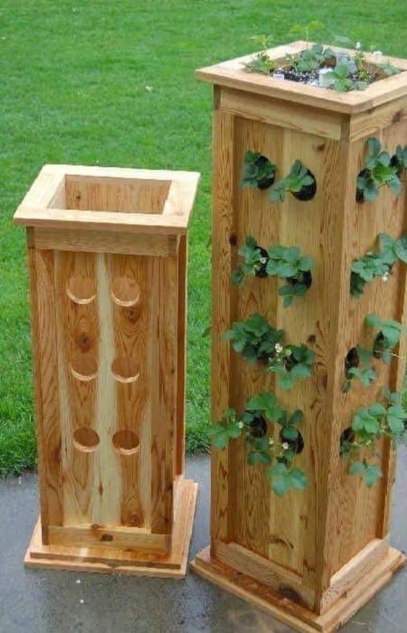 two wooden planters sitting next to each other