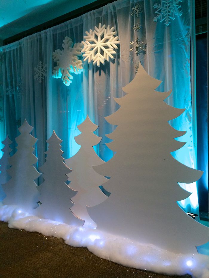 a decorated stage with snowflakes and christmas trees