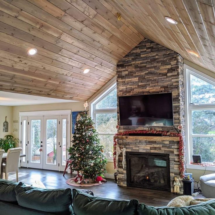 a living room filled with furniture and a fire place under a flat screen tv mounted on a wall