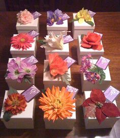 there are many small boxes that have flowers in them on top of each box,