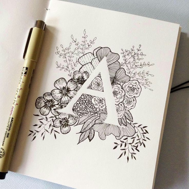 the letter a is surrounded by flowers and crochet stitchs, along with a pen