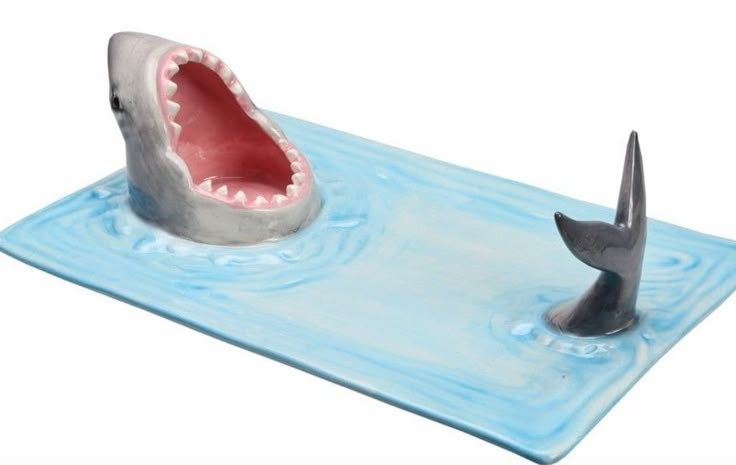 a fake shark is in the water with a hammer