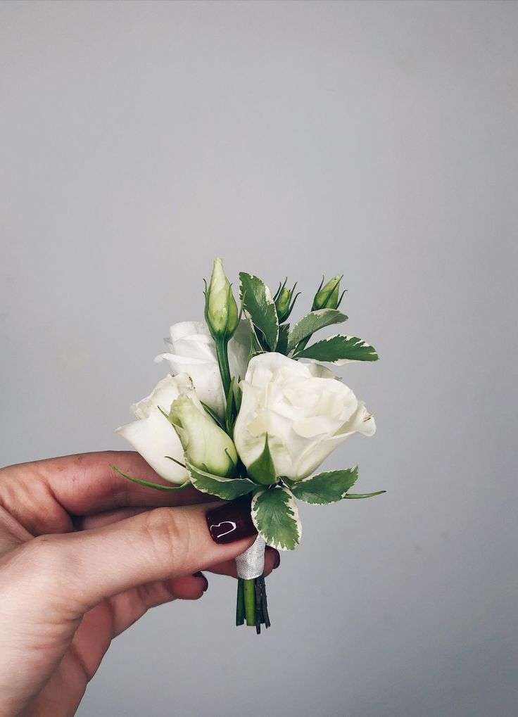 a person holding a bouquet of flowers in their hand