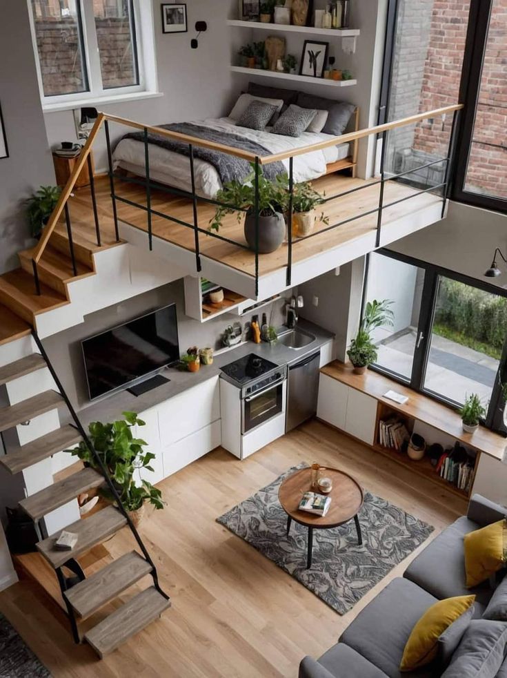 an overhead view of a living room with stairs leading up to the bedroom and kitchen