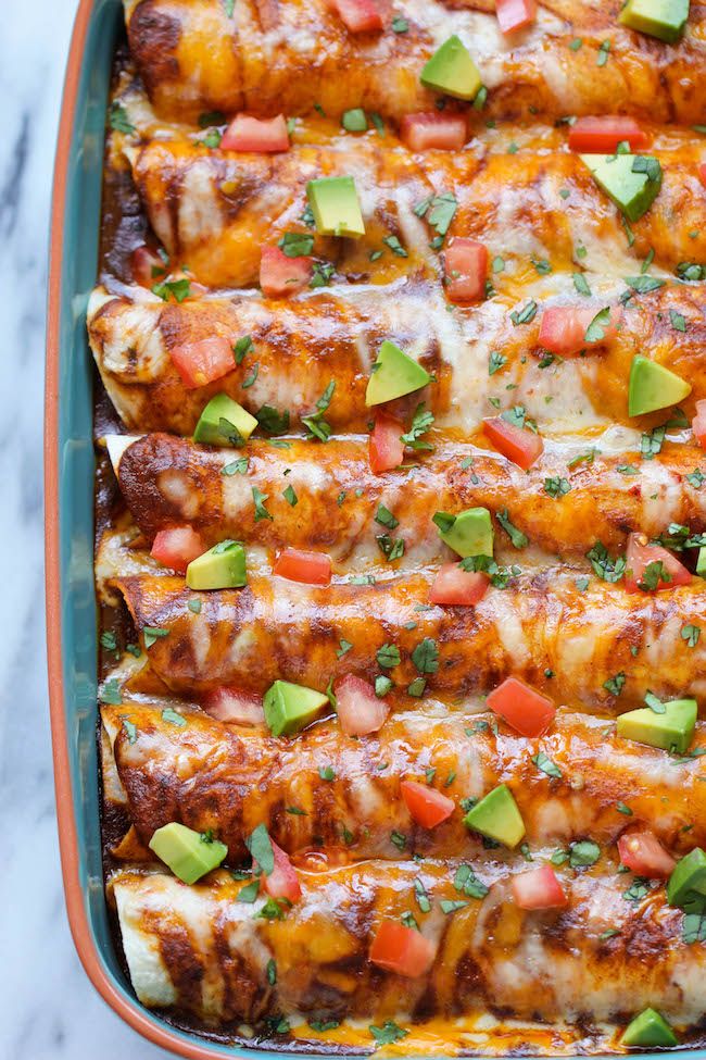 chicken enchilada casserole with tomatoes, avocado and cilantro