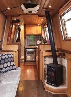 the interior of a tiny home with wood paneling and wooden flooring is shown