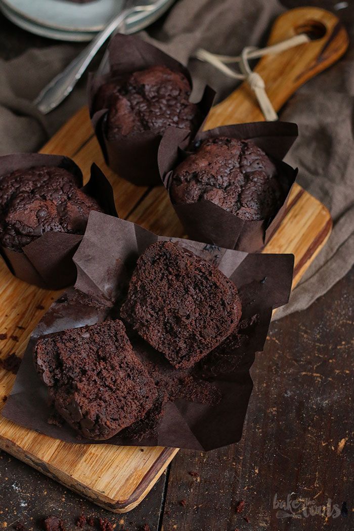 several chocolate muffins on a wooden board