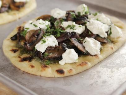 two flatbreads topped with mushrooms and cottage cheese