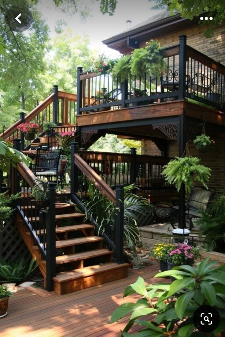 an outdoor deck with stairs and potted plants