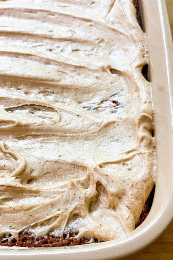 a close up of a cake in a pan with frosting on the top and bottom