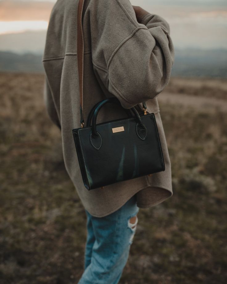 The Box Bag is close to our heart. It’s classic look and clean lines make this bag a staple in any wardrobe. With the flawless stitching and handcrafted tubular handles, it offers an sense of understated sophistication. This bag can be customized in countless variations. We recommend emailing us if you are wanting to order this bag so we can customize this favorite to your personal style. The bag can be carried by hand with the rolled leather handles, or worn either on the shoulder or cross-body Classic Top Handle Box Bag For On-the-go, Classic Top Handle Box Bag, Classic Everyday Box Bag With Handles, Classic Box Bag With Leather Handles For Everyday, Timeless Satchel Box Bag For Everyday, Timeless Everyday Satchel Box Bag, Timeless Everyday Box Bag Satchel, Classic Square Satchel For On-the-go, Rectangular Leather-handled Satchel For Daily Use