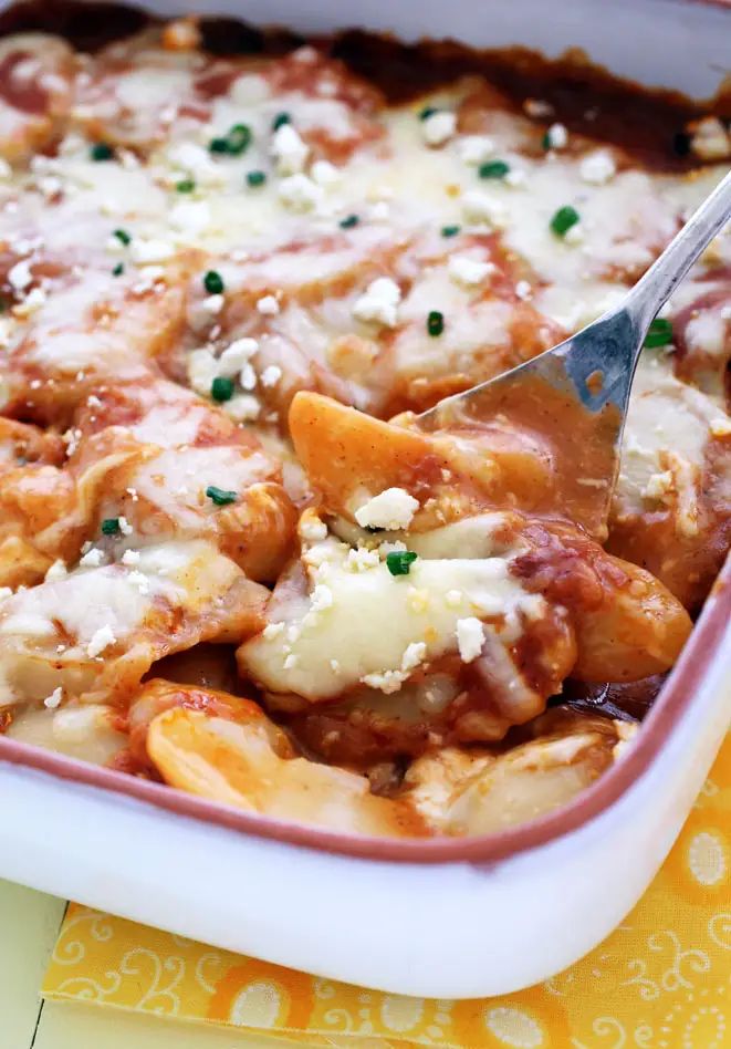 a close up of a casserole dish with meat and cheese on it,