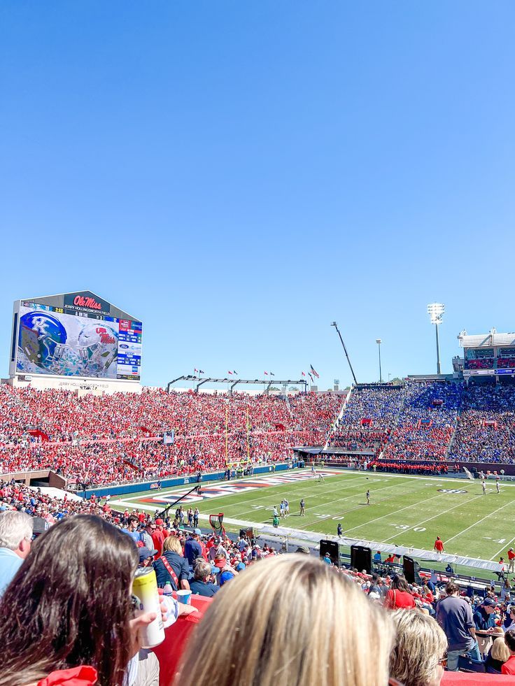 a stadium full of people watching a football game