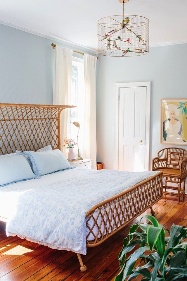 an instagramted photo of a bedroom with blue walls and white bed linens