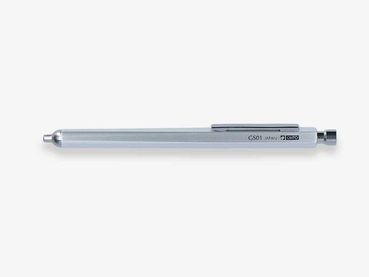 a pen is sitting on top of a white surface