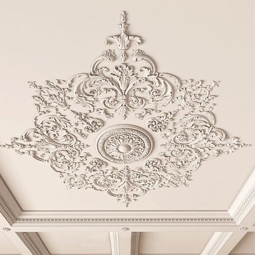 the ceiling is decorated with intricate white paint and decorative designs on it's walls