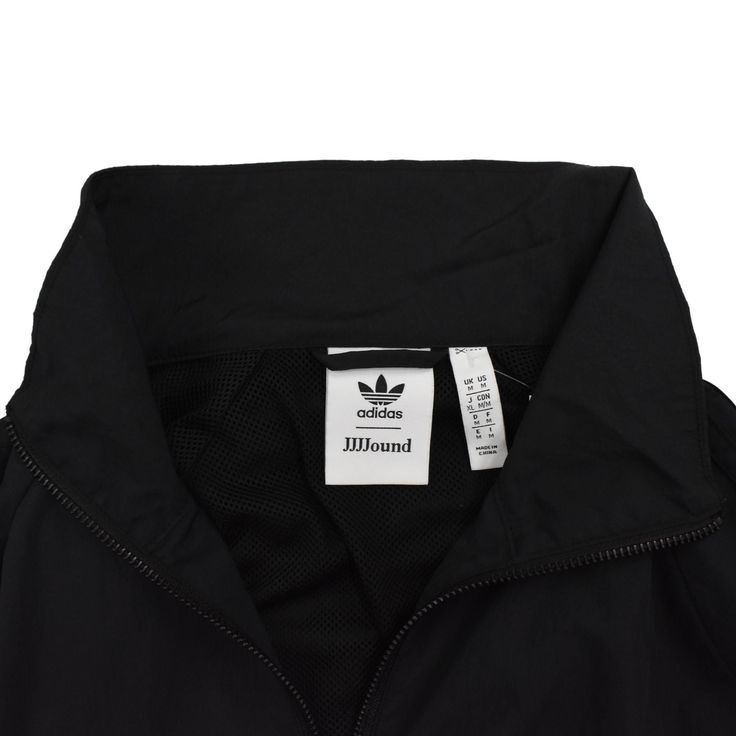 Adidas x JJJJound track jacket in black nylon with black zip hardware, front pockets, an elastic waist, and black classic 3 stripe trim down the sleeves. Brand = Adidas Size = Medium Condition = 8/10, Very good Material = Nylon SKU = 4615-339 Adidas Nylon Track Jacket For Streetwear, Adidas Technical Track Jacket For Streetwear, Functional Black Nylon Track Jacket, Black Technical Nylon Windbreaker, Technical Black Windbreaker For Fall, Black Technical Windbreaker For Fall, Adidas Functional Nylon Track Jacket, Athleisure Nylon Track Jacket With Three Stripes Branding, Athleisure Nylon Track Jacket With Three Stripes