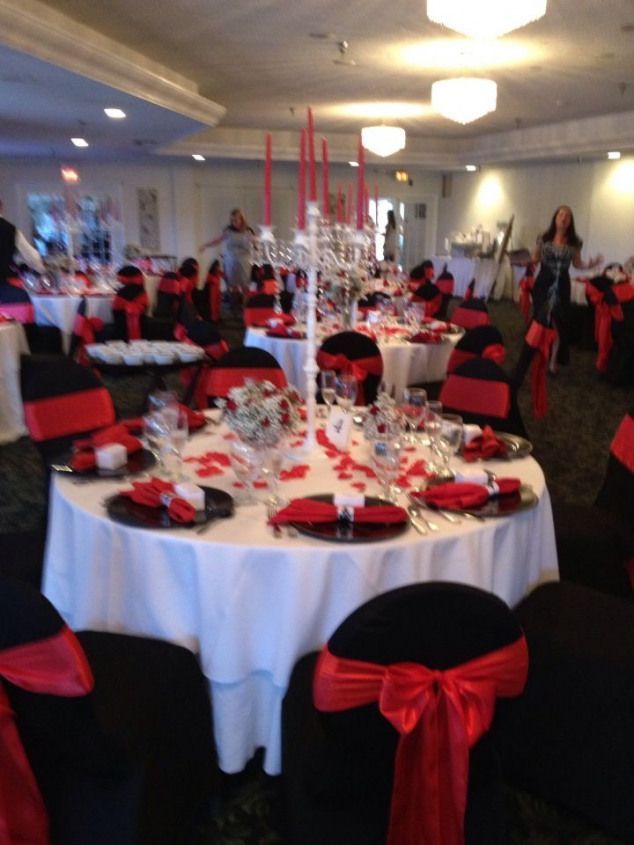 the tables are set with red and black linens