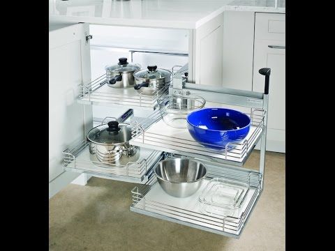 an image of a kitchen corner with pots and pans on the bottom shelf below