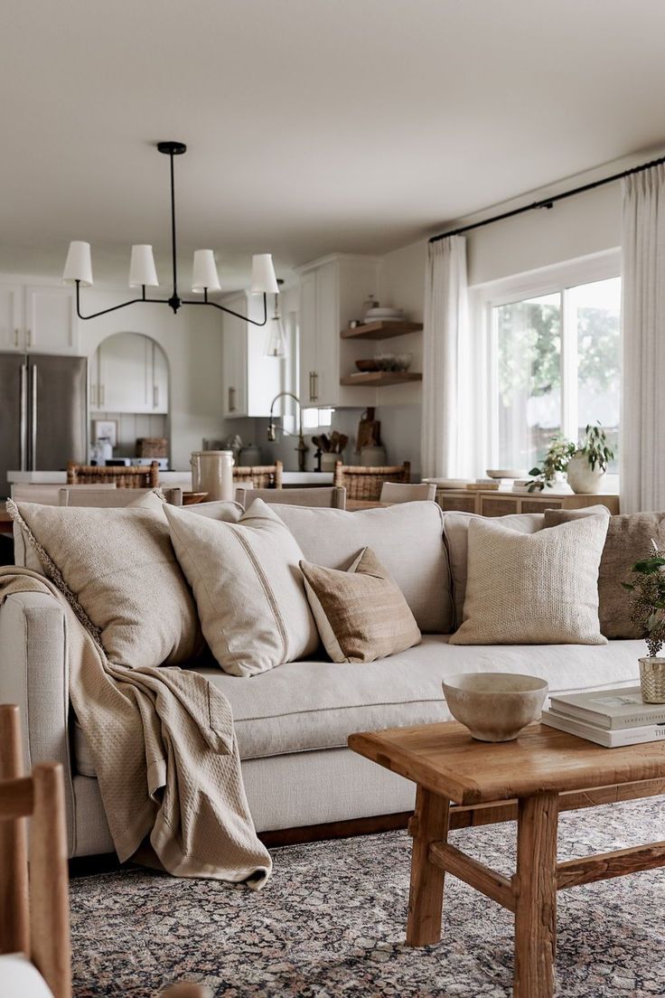 a living room filled with furniture and pillows