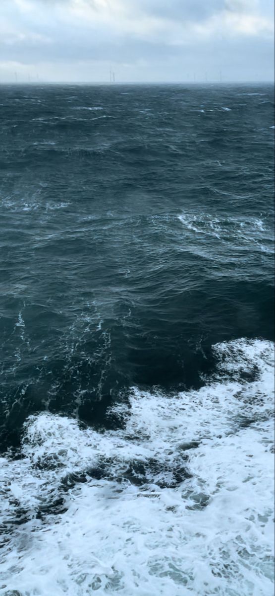 the ocean is very choppy and dark blue