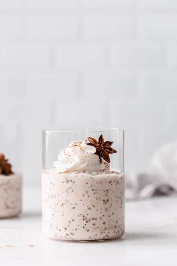 two small jars filled with food on top of a white counter next to each other