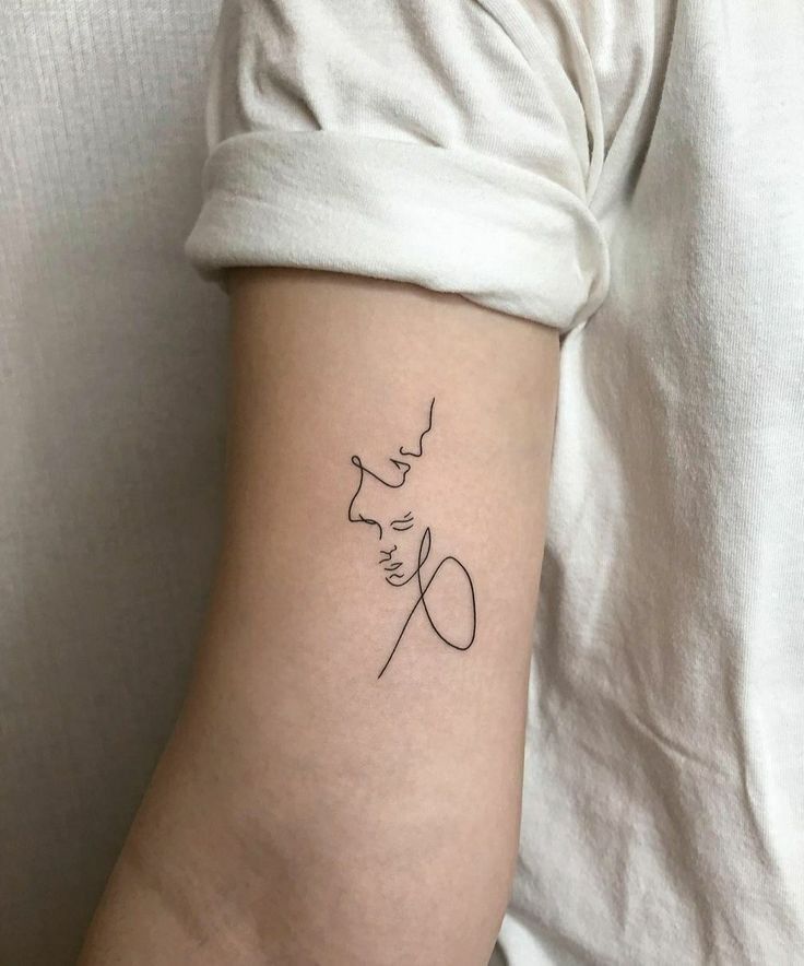 a woman's arm with a small tattoo on the left side of her arm