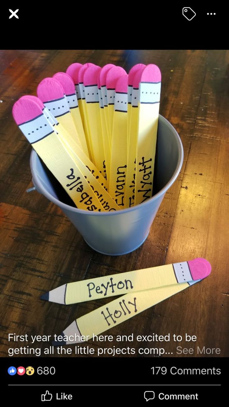 a bucket full of pencils sitting on top of a wooden table