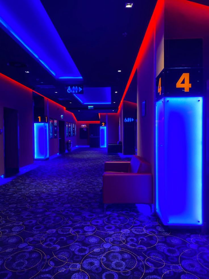 an empty hallway with blue and red lighting