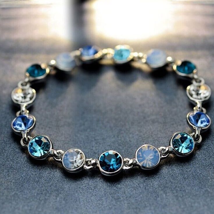 Dive into Elegance with Our Ocean Tranquility Bracelet! Adorn your wrist with the mesmerizing allure of the deep blue sea. This stunning masterpiece combines sophistication and style. The piece is a celebration of timeless beauty from Pacific West Made Jewelry. ✨ Sparkling Gemstones: Each bracelet is adorned with deep blue gemstones that shimmer and dance with every movement, capturing the essence of the ocean depths. The rich, vibrant hues add a touch of luxury to any ensemble. 🌟 Statement Piece: Make a statement wherever you go with this bold and elegant bracelet. Whether you're dressing up for a special occasion or adding a touch of glamour to your everyday look, this accessory effortlessly elevates your style. 🎁 Perfect Gift: Surprise your loved ones with a gift that reflects their u Coquette Bracelets, Fake Lip Ring, Champagne Gold Color, Gems Bracelet, Stylish Bracelet, Bangle Bracelets With Charms, Elegant Bracelet, American Fashion, Charm Bangle