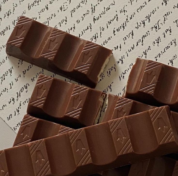 several pieces of chocolate sitting on top of a piece of paper