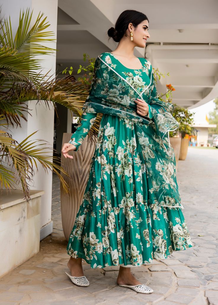 PRODUCT DESCRIPTION :-Flaunt the traditional Aesthetics with this beautiful bottle green floral printed tier pattern Anarkali . It is all set to steal the hearts with it`s pretty print and details.Anarkali :- chanderi cottonPant :- CottonDupatta :- Organza silkClosure Used:- Side zipColor:-Anarkali and dupatta - bottle green Pant - off whiteCare Instructions :- Dry clean onlyModel Size :- Model is wearing XS sizeModel Height :- 5.6''DISCLAIMER :- Slight color variations may occur due to differen Green Floral Sharara For Navratri, Green Anarkali Set With Printed Motifs And Maxi Length, Green Floor-length Anarkali Set With Printed Motifs, Green Bollywood Anarkali Set With Printed Motifs, Green Bollywood Style Sharara With Floral Print, Bollywood Style Green Floral Sharara, Green Sharara With Floral Print, Green Bohemian Georgette Kurta, Green Sharara With Printed Motifs For Wedding