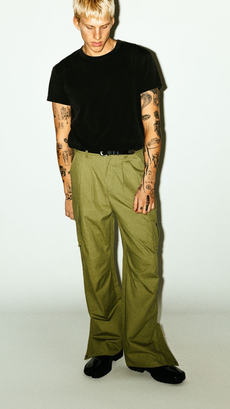 A utility cargo for the ultimate off-duty uniform. Easy-going and relaxed, these cargos are pleated for a slightly wider, straight-leg silhouette. Open the side-zip hems for a sportier 90's aesthetic. Dress down formal blazers and button-ups with an effortless, casual contrast. Relaxed Fit Straight Cargo Pants, Relaxed Fit Cargo Parachute Pants, Casual Cargo Pants With Side Pockets And Straight Hem, Military Style Cargo Bottoms With Relaxed Fit, Military Style Relaxed Fit Wide Leg Parachute Pants, Urban Cargo Pants Straight Relaxed Fit, Relaxed Fit Military Cargo Bottoms, Green Relaxed Fit Cargo Pants With Patch Pockets, Utility Style Cargo Pants With Straight Hem