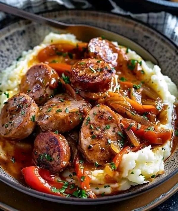 a bowl filled with mashed potatoes and sausage