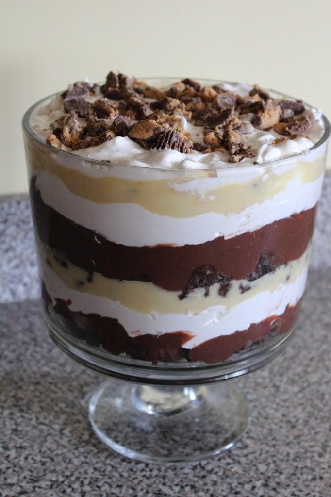 a dessert with chocolate, cream and walnuts in a glass dish