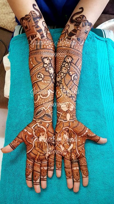 two hands with henna designs on them