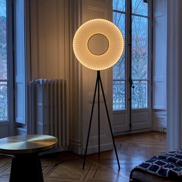 a floor lamp in the middle of a room